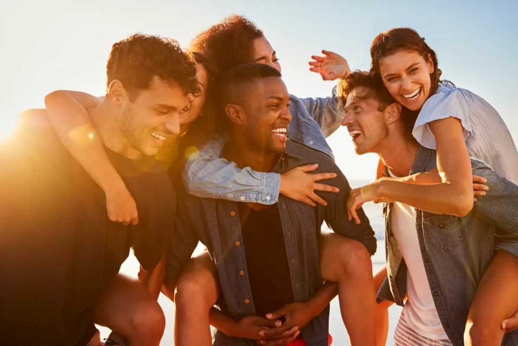 group of friends on vacation having piggyback race utc